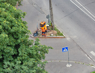 Workers installing a new street lamp post.