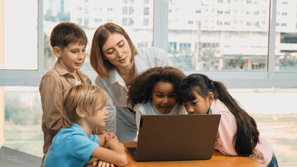 Cute african girl programing system while surround with caucasian teacher and diverse friend....