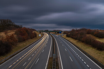 Highway near Krusne mountains with night lines from cars