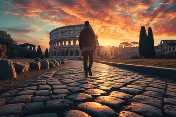 Wall murals Colosseum Man Walking Towards the Colosseum at Sunrise in Rome, Italy