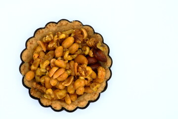 Pie with mixed nuts. Close up and isolated on a white background.