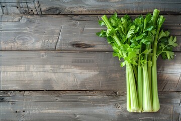 Green fresh celery sticks on wooden background