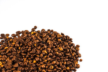 Coffee beans on a white background. A heap of coffee beans on white. Morning coffee