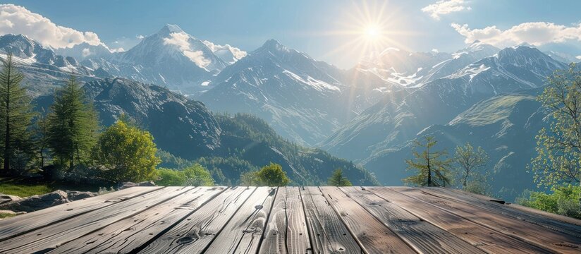 A wooden deck with views of majestic mountains in the background under a clear sky.
