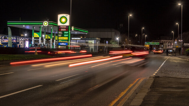 A BP petrol station forecourt with passing traffic. Stourbridge, UK - February 20, 2024