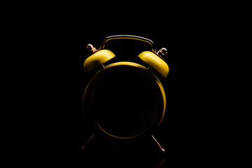 Alarm clock silhouette on a black background, only the outline is visible, advertising concept.