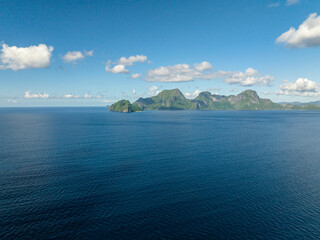 Helicopter Island and Cadlao Island with blue sea. Blue sky and clouds. El Nido, Philippines.