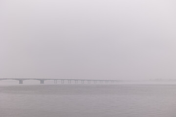 Bridge over the river in the fog