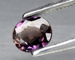 natural purple sapphire gem on the background