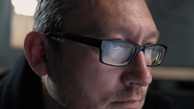 Mature male manager in glasses working behind a computer screen. Portrait. Close-up  