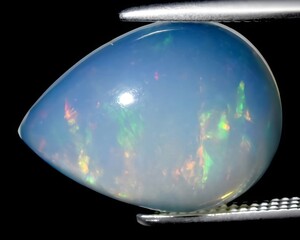 natural rainbow multi color opal gem on the background