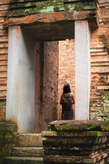 Tourist admiring the interior of one of the temples of Sambor Prei in Cambodia.