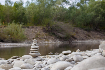 Amazing round stone near a flowing river, Stones are perfectly balanced on one another and forming, These are river stones, or also buddha stones