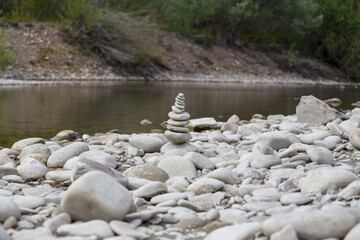 Amazing round stone near a flowing river, Stones are perfectly balanced on one another and forming, These are river stones, or also buddha stones