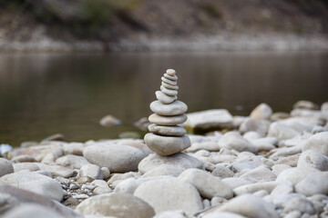 Amazing round stone near a flowing river, Stones are perfectly balanced on one another and forming, These are river stones, or also buddha stones