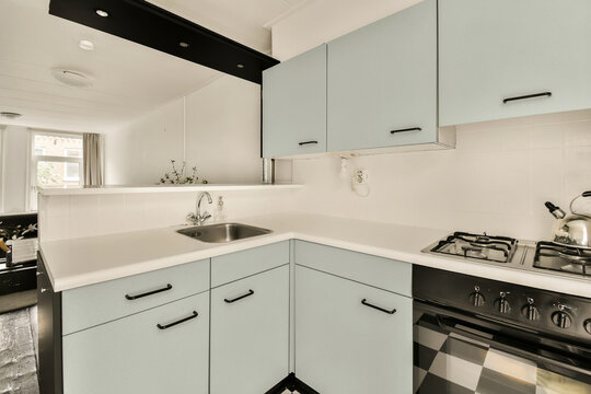 Modern kitchen interior with light blue cabinets