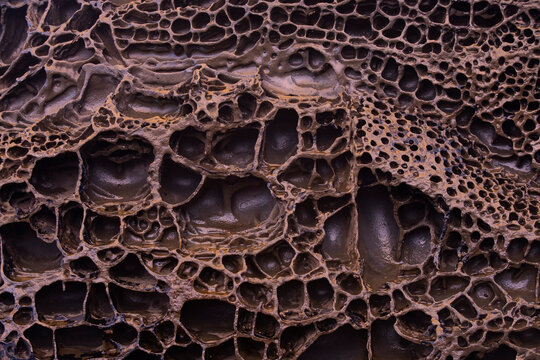 Textured iron-rich rock formations from Llumeres beach, Asturias