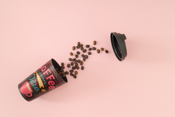 Coffee is always a good idea. Creative layout made with coffee cup and roasted coffee beans on light pink background. Minimal take away coffee concept. Trendy coffee to go idea. Flat lay, top of view.