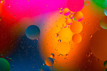 movement of oil bubbles in the liquid. Fantastic structure of colorful bubbles. Colorful artistic image of oil drop floating on the water