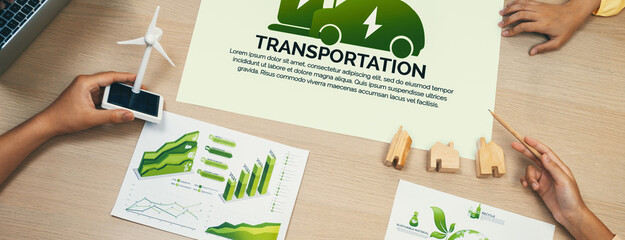 Electric vehicle poster placed on meeting table at green business meeting. ESG environment social...