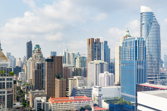 Closeup image of Bangkok cityscape. Modern cityscape surrounded with architectural building with day light and blue sky. Side view. Business background. Day light. Ornamented.
