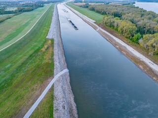 towboats with barges on Chain of Rock Canal of Mississippi River above St Louis, aerial view in October scenery