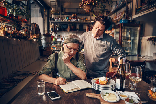 Owners managing restaurant business and reviewing finances