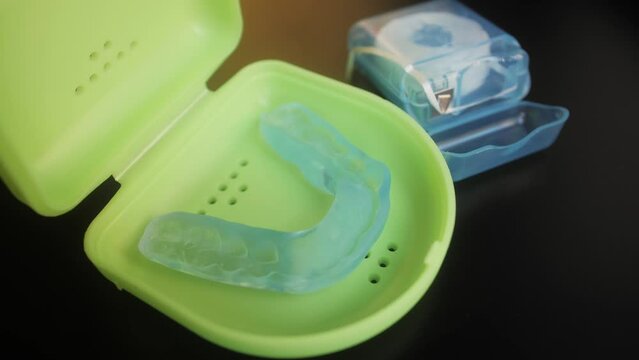 Dental floss and mouthguard for teeth on dressing table. Dental healthcare and Orthodontic concept.