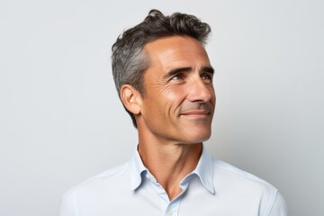 Portrait of a handsome middle-aged man in a white shirt - obrazy, fototapety, plakaty
