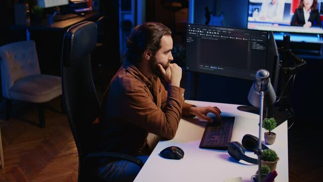 Computer engineer deliberating ways of fixing errors while developing code on PC. IT professional brainstorming ways of solving database errors, remotely working from home, camera B