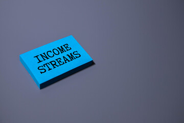 income streams . text on a notebook. notepad on wooden table. business concept.