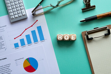 There is wood cube with the word ROE. It is an abbreviation for Return On Equity as eye-catching image.