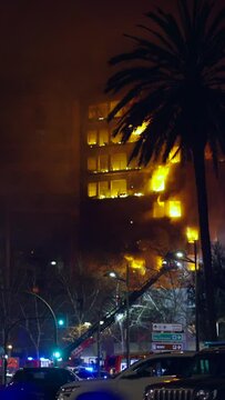 Police cars surround burning building