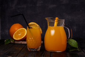 Still life of a glass of fresh orange juice on a vintage wooden table with copy space background