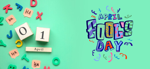 Date of April Fool's Day with letters and sticky papers on color background