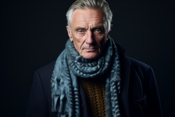 Portrait of a senior man wearing a winter coat and scarf.