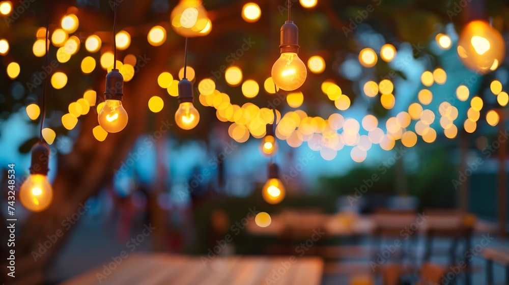 Poster blurred bokeh light with yellow string lights decor in beach restaurant at dusk of summer background : Generative AI