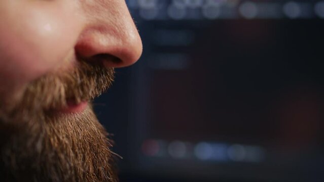Happy computer scientist feeling satisfied after removing all bugs while coding on workstation desktop. Teleworking upbeat IT specialist pleased after solving script errors, camera B extreme close up