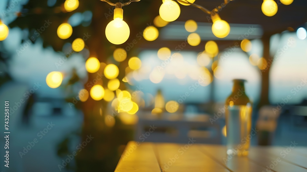 Poster blurred bokeh light with yellow string lights decor in beach restaurant at dusk of summer background : Generative AI