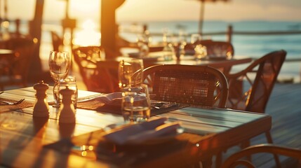 Sea sunset in modern luxury restaurant with terrace Outdoor restaurant at the beach with pair of chair Table setting at tropical beach restaurant Elegant hotel or resort restaurant : Generative AI - obrazy, fototapety, plakaty
