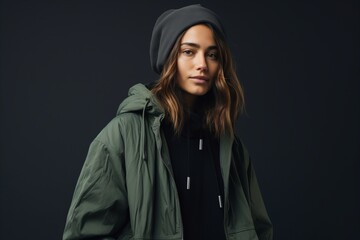 Portrait of a beautiful young woman in a green jacket and hat.