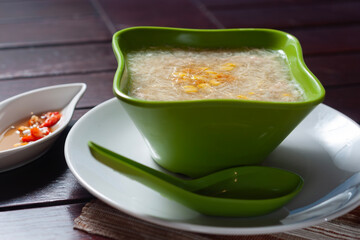 Chicken corn soup served in a green bowl