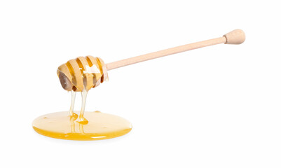Natural honey dripping from dipper on white background