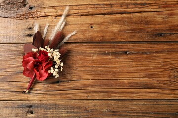 Beautiful boutonniere on wooden background, top view. Space for text - obrazy, fototapety, plakaty