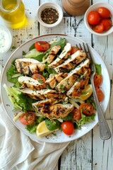 a delicious caesar salad with grilled chicken on a white wooden tabletop