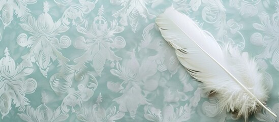 A white feather is delicately resting on a vibrant green wallpaper, showcasing a beautiful contrast between nature and man-made design elements. The intricate patterns of the wallpaper complement the