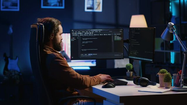 Experienced programmer writing code on computer screen while in office using java programming languages. Developer working on fixing database errors while working from home, camera A