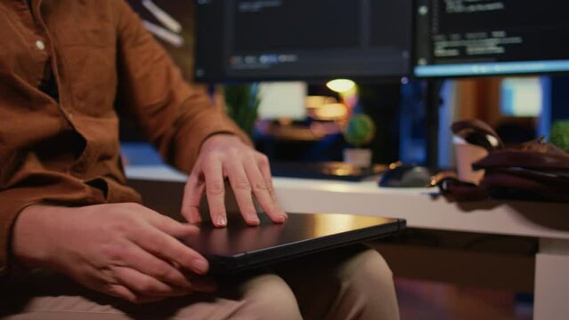 Remote programmer starting job shift in personal office at home, taking laptop out of bag. Teleworker unpacking backpack, writing lines of code on notebook keyboard, camera B close up