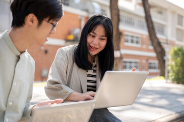 A friendly Asian female student is discussing work and helping her friend with math homework.