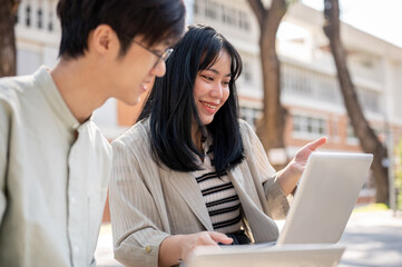 A friendly Asian female student is discussing work and helping her friend with math homework.